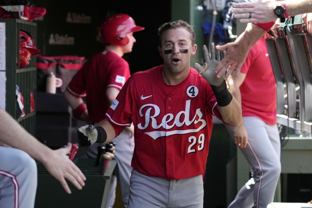 Cincinnati Reds' TJ Friedl celebrates with teammates after hitting a three-run home run during the second inning of a baseball game against the Chicago Cubs in Chicago, Sunday, June 2, 2024. (AP Photo/Nam Y. Huh)