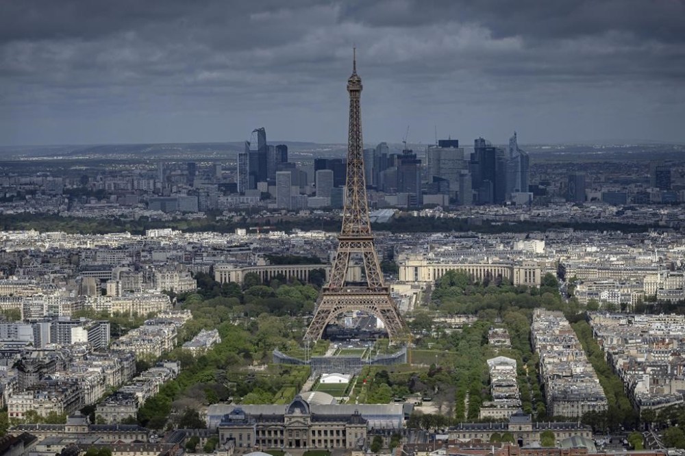 FILE - Stands are under construction on the Champ-de-Mars in front of the Eiffel Tower, Monday, April 15, 2024 in Paris. La Dame de Fer (The Iron Lady) needs no introduction and is still going strong at 1235 years old. Men's and women's volleyball players get to compete at the feet of the 330-meter tower and will be watched by nearly 13,000 fans at the temporary Eiffel Tower Stadium. (AP Photo/Aurelien Morissard, File)