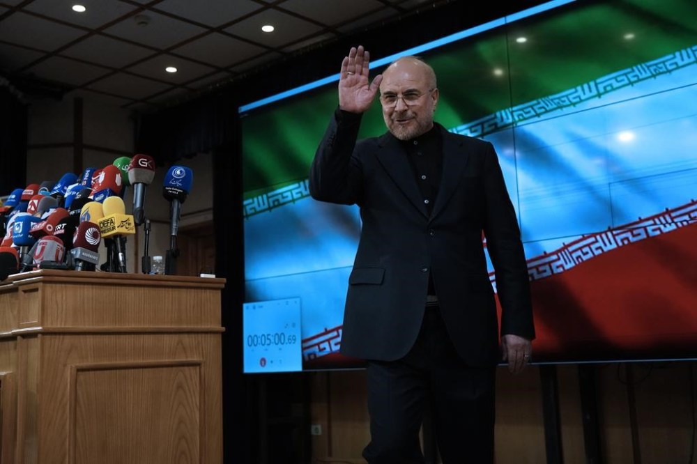 Iran's hard-line parliament speaker Mohammad Bagher Qalibaf waves to the media at the conclusion of a press briefing after registering his name as a candidate for the June 28 presidential election at the Interior Ministry, in Tehran, Iran, Monday, June 3, 2024. The entry of Qalibaf brings a prominent candidate with close ties to the country's paramilitary Revolutionary Guard into the vote to replace President Ebrahim Raisi, who died in a helicopter crash with seven others on May 19. (AP Photo/Vahid Salemi)