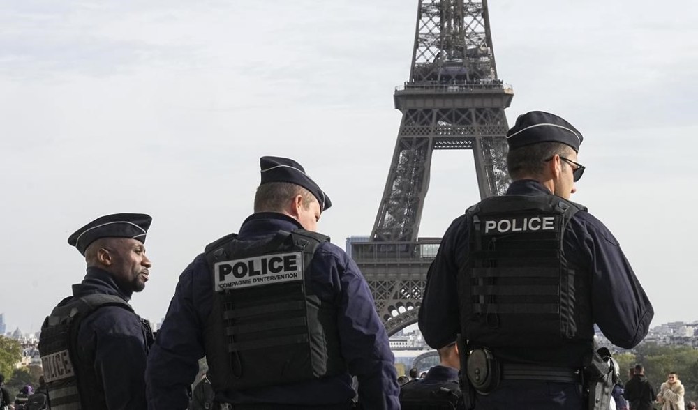 FILE - Police officers patrol the Trocadero plaza near the Eiffel Tower in Paris, Tuesday, Oct. 17, 2023. French prosecutors said on Monday June 3, 2024 that three men have been placed under judicial investigation on suspicion of perpetrating