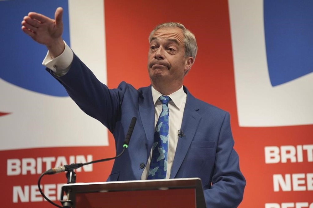 Nigel Farage speaks during a press conference to announce that he will become the new leader of Reform UK and that he will stand as the parliamentary candidate for Clacton, Essex, at The Glaziers Hall in London, Monday June 3, 2024. while on the General Election campaign trail. (Yui Mok/PA via AP)
