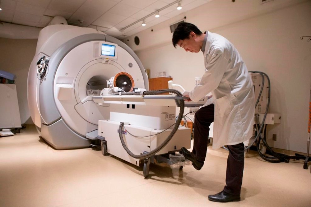 Ontario is looking to boost the number of publicly funded MRIs and CT scans offered through private clinics. A member of a medical team prepares a MRI machine before a procedure at Toronto's Sunnybrook Hospital on Tuesday May 1, 2018. THE CANADIAN PRESS/Chris Young