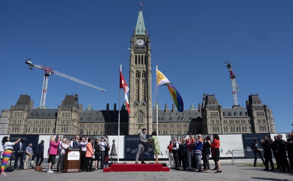 Prime Minister Justin Trudeau and Women and Gender Equality and Youth Minister Marci Ien raise the pride flag during an event on Parliament Hill, in Ottawa, Monday, June 3, 2024. THE CANADIAN PRESS/Adrian Wyld