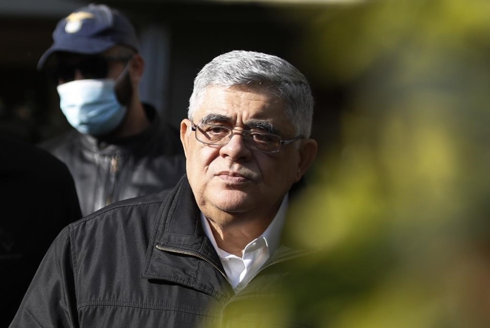 FILE - Golden Dawn party leader Nikolaos Michaloliakos, escorted by police officers leaves his residence in Athens, Oct. 22, 2020. The head of Greece’s extreme far-right Golden Dawn party will return to prison after a council of judges rescinded his early conditional release on Monday June 3, 2024. Nikos Michaloliakos was arrested in his Athens home following the decision, and will be taken back to prison just over a month after his release. (AP Photo/Thanassis Stavrakis, file)
