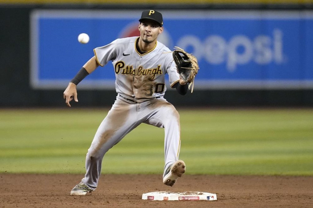 FILE - Pittsburgh Pirates shortstop Tucupita Marcano takes a throw down to second base during the fifth inning of a baseball game against the Arizona Diamondbacks, July 7, 2023, in Phoenix. San Diego Padres' Marcano is under investigation by Major League Baseball for allegedly betting on baseball and could be subject to a possible lifetime ban, according to a person familiar with the probe who spoke to The Associated Press on condition of anonymity because the investigation is ongoing. (AP Photo/Ross D. Franklin, File)
