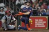 Houston Astros' Kyle Tucker right, grimaces after fouling a pitch off his leg as St. Louis Cardinals catcher Iván Herrera watches during the third inning of a baseball game Monday, June 3, 2024, in Houston. (AP Photo/David J. Phillip)