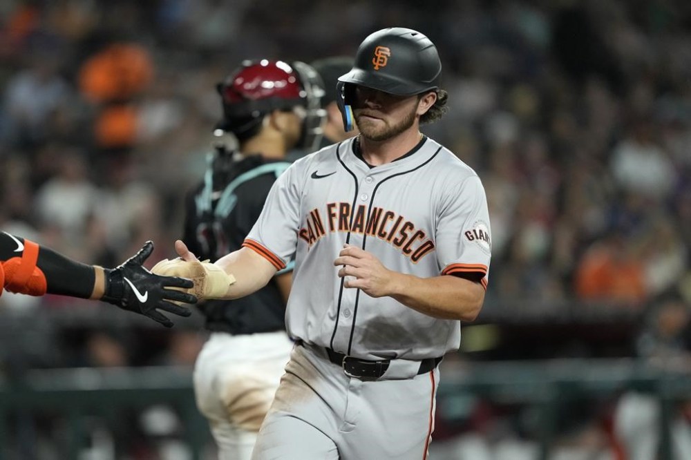 San Francisco Giants' Brett Wisely scores on a double hit by Matt Chapman during the fourth inning of a baseball game against the Arizona Diamondbacks, Monday, June 3, 2024, in Phoenix. (AP Photo/Matt York)
