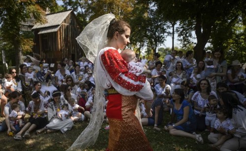 FILE - A woman wearing a traditional Romanian blouse, known in Romanian as an 