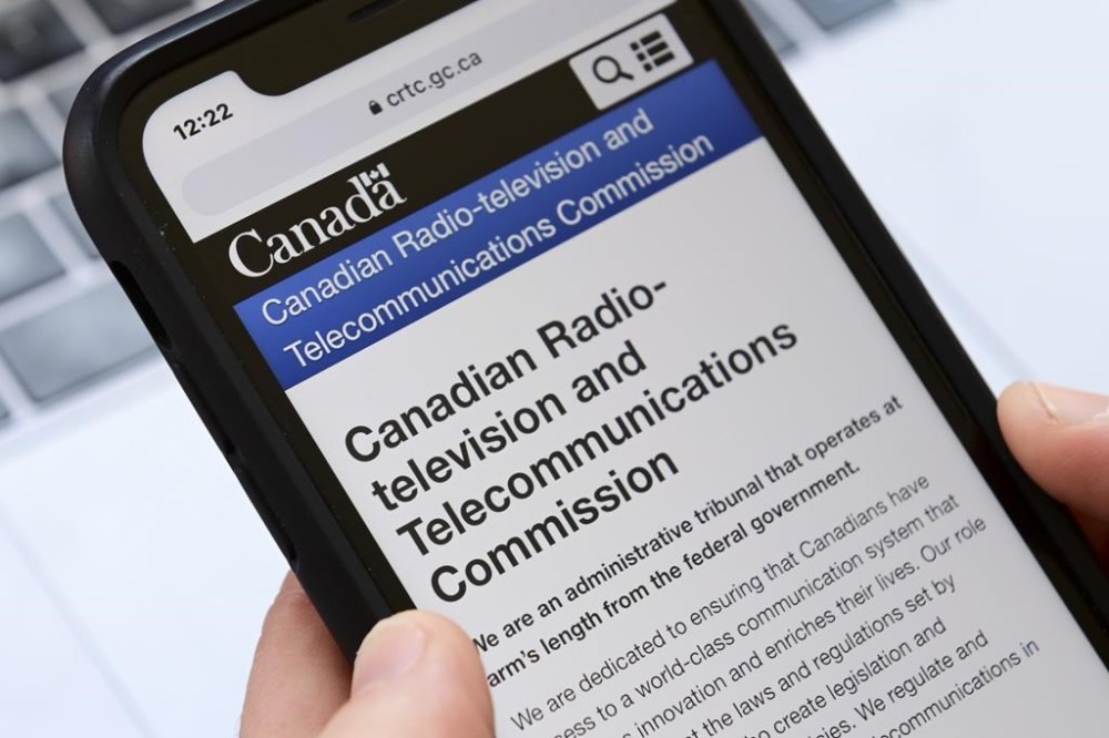 A person navigates to the online social-media pages of the Canadian Radio-television and Telecommunications Commission (CRTC) on a cellphone in Ottawa on Monday, May 17, 2021. THE CANADIAN PRESS/Sean Kilpatrick