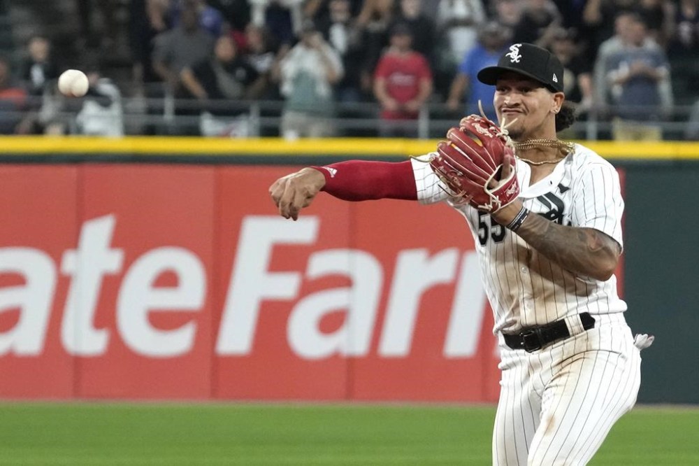 FILE - Chicago White Sox second baseman Jose Rodriguez throws out Texas Rangers' Jonah Heim at first base during the ninth inning of a baseball game in Chicago, Tuesday, June 20, 2023. Major League Baseball, on Tuesday, June 4, 2024, banned Rodriguez for one year after finding the player placed unrelated bets with a legal sportsbook. (AP Photo/Nam Y. Huh, File)