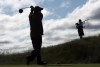 Caledon, Ont., is preparing to welcome the world — through the RBC Canadian Open — to its rolling green hills. Golf course architect Doug Carrick tees off as bagpiper Kristen MacKay stands by the first tee during the Osprey Valley Heathlands 25th anniversary celebration in Caledon, Ont., Tuesday, July 25, 2017. THE CANADIAN PRESS/Frank Gunn