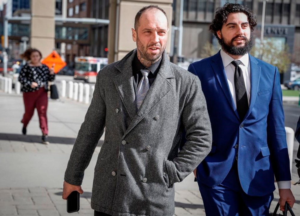 Almost two years to the day after 86-year-old Betty Ann Williams was mauled to death in a dog attack, the owner of the pit bills appeared in court trying to keep two of the animals from being put down. Dog owner Dennis Bagaric, centre, pleaded guilty to two bylaw charges. He leaves court after a sentencing hearing in Calgary, Monday, May 6, 2024. THE CANADIAN PRESS/Jeff McIntosh