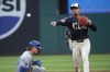 Cleveland Guardians' Andres Gimenez throws to first after forcing out Kansas City Royals' Vinnie Pasquantino at second on a double play hit into by Salvador Perez during the seventh inning of a baseball game in Cleveland, Tuesday, June 4, 2024. (AP Photo/Phil Long)