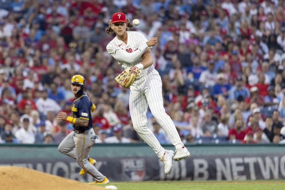 Philadelphia Phillies third baseman Alec Bohm throws to first for the out on Milwaukee Brewers' Christian Yelich during the sixth inning of a baseball game Tuesday, June 4, 2024, in Philadelphia. (AP Photo/Laurence Kesterson)