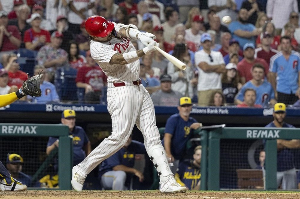 Philadelphia Phillies' Nick Castellanos drives in the winning run with a double during the 10th inning of the team's baseball game against the Milwaukee Brewers, Tuesday, June 4, 2024, in Philadelphia. (AP Photo/Laurence Kesterson)