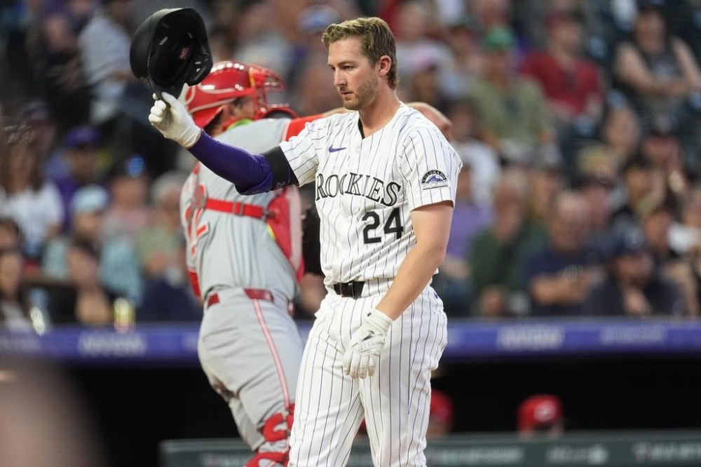 Colorado Rockies' Ryan McMahon tosses his batting helmet after striking out against Cincinnati Reds starting pitcher Frankie Montas to end the sixth inning of a baseball game Tuesday, June 4, 2024, in Denver. (AP Photo/David Zalubowski)