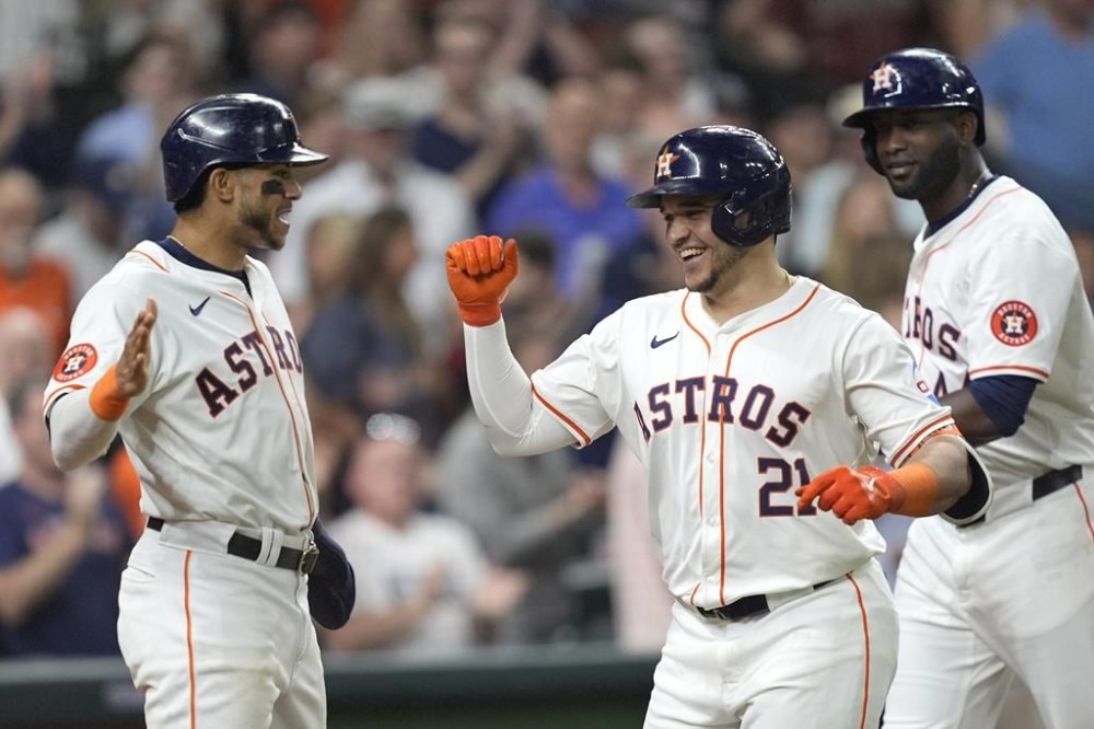 Houston Astros' Yainer Diaz (21) celebrates with Jeremy Peña, left, and Yordan Alvarez after they scored on Diaz's three-run home run against the St. Louis Cardinals during the third inning of a baseball game Tuesday, June 4, 2024, in Houston. (AP Photo/David J. Phillip)