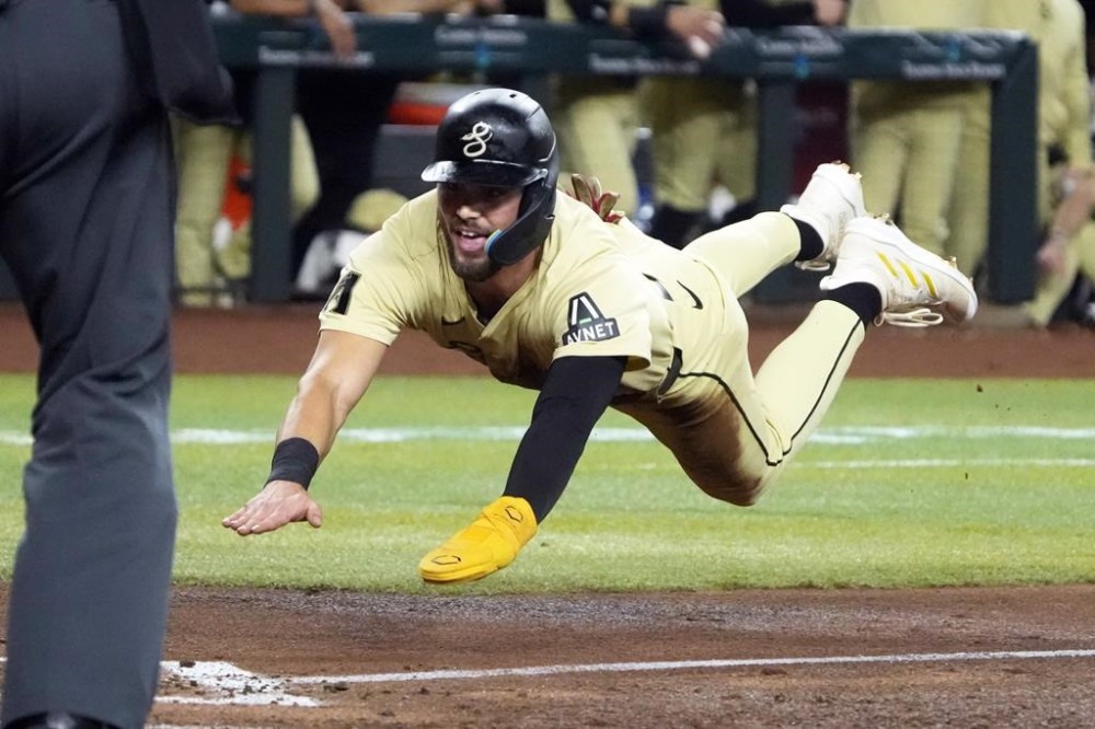 Arizona Diamondbacks' Blaze Alexander scores against the San Francisco Giants during the third inning of a baseball game Tuesday, June 4, 2024, in Phoenix. (AP Photo/Rick Scuteri)