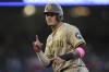 San Diego Padres' Manny Machado gestures at first base after singling during the third inning of the team's baseball game against the Los Angeles Angels in Anaheim, Calif., Tuesday, June 4, 2024. (AP Photo/Eric Thayer)