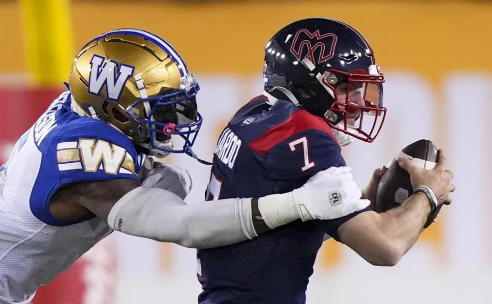 Montreal Alouettes quarterback Cody Fajardo (7) is sacked by Winnipeg Blue Bombers defensive end Willie Jefferson (5) during the first half of football action at the 110th CFL Grey Cup in Hamilton, Ont., on Sunday, Nov. 19, 2023. THE CANADIAN PRESS/Nathan Denette