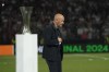 Fiorentina's head coach Vincenzo Italiano walks disappointed next to the Conference League trophy at the end of the Conference League final soccer match between Olympiacos FC and ACF Fiorentina at OPAP Arena in Athens, Greece, Thursday, May 30, 2024. Olympiacos won 1-0. (AP Photo/Thanassis Stavrakis)
