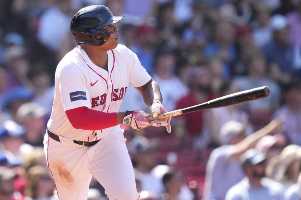 Boston Red Sox's Rafael Devers watches the flight of his two-run home run in the seventh inning of a baseball game against the Atlanta Braves, Wednesday, June 5, 2024, at Fenway Park in Boston. (AP Photo/Charles Krupa)
