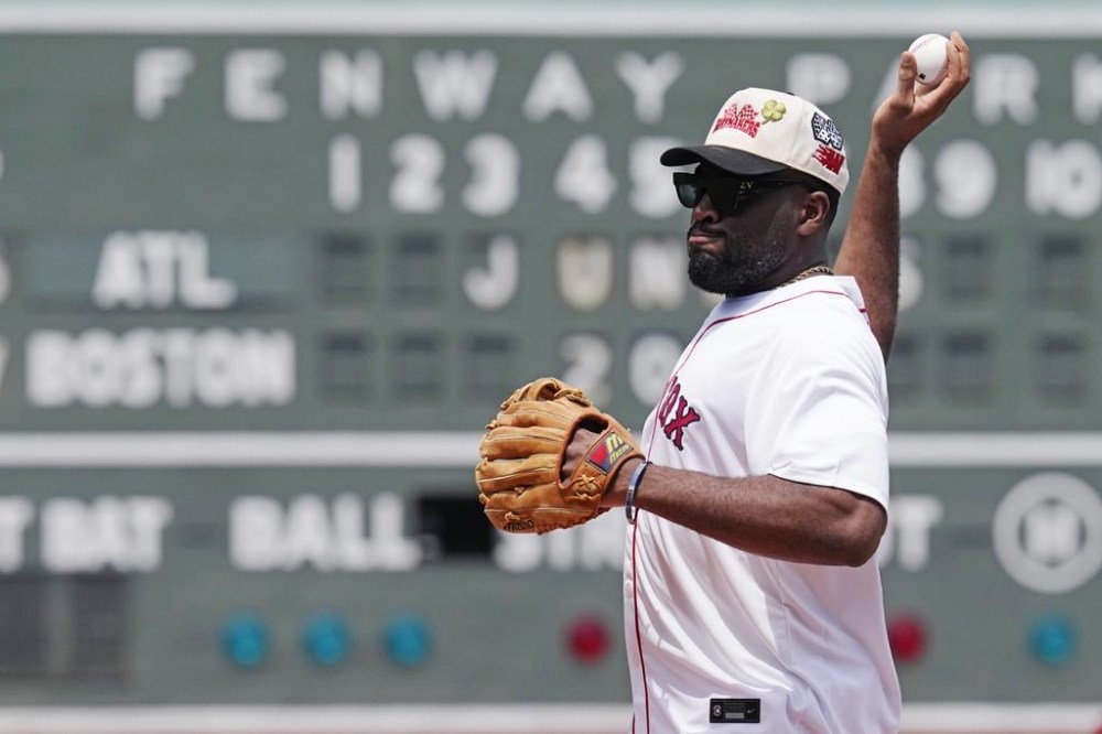 New England Patriots linebacker Josh Uche delivers the ceremonial first pitch prior to a baseball game between the Boston Red Sox and Atlanta Braves, Wednesday, June 5, 2024, at Fenway Park in Boston. (AP Photo/Charles Krupa)