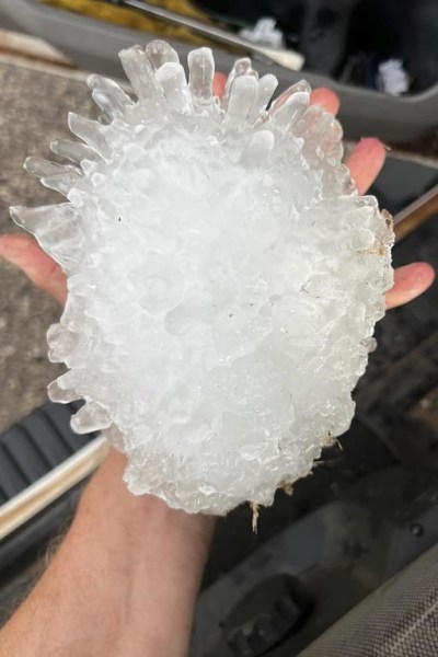 This photo provided by KWTV shows a hail stone, Sunday, June 2, 2024, near Vigo Park, Texas. The National Weather Service in Lubbock, Texas, said they believe the stone, which measured more than 7 inches long, is a new state record. (Val Castor/KWTV via AP)