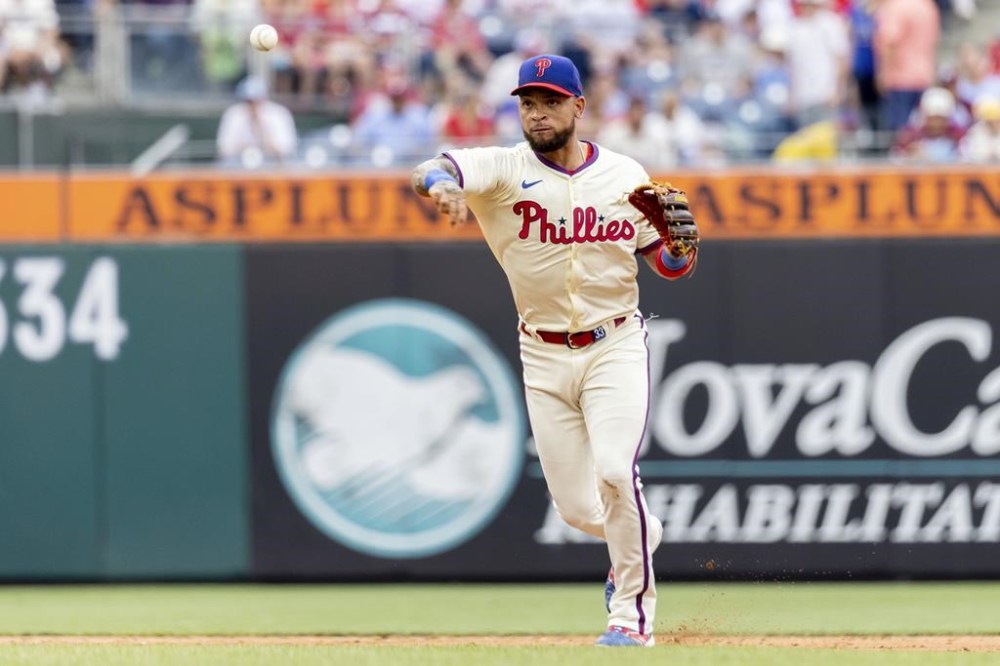 Philadelphia Phillies shortstop Edmundo Sosa throws to first for the out on Milwaukee Brewers' Brice Turang during the third inning of a baseball game, Wednesday, June 5, 2024, in Philadelphia. (AP Photo/Laurence Kesterson)