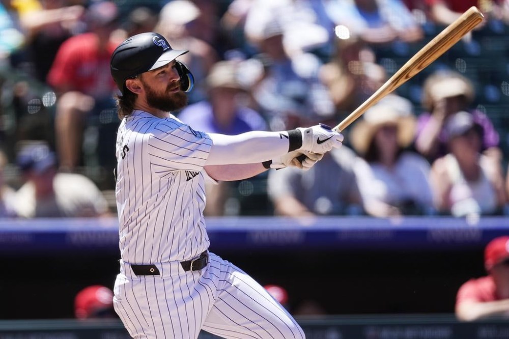 Colorado Rockies' Brendan Rodgers drives in two runs with a single off of Cincinnati Reds starting pitcher Graham Ashcraft in the first inning of a baseball game Wednesday, June 5, 2024, in Denver. (AP Photo/David Zalubowski)