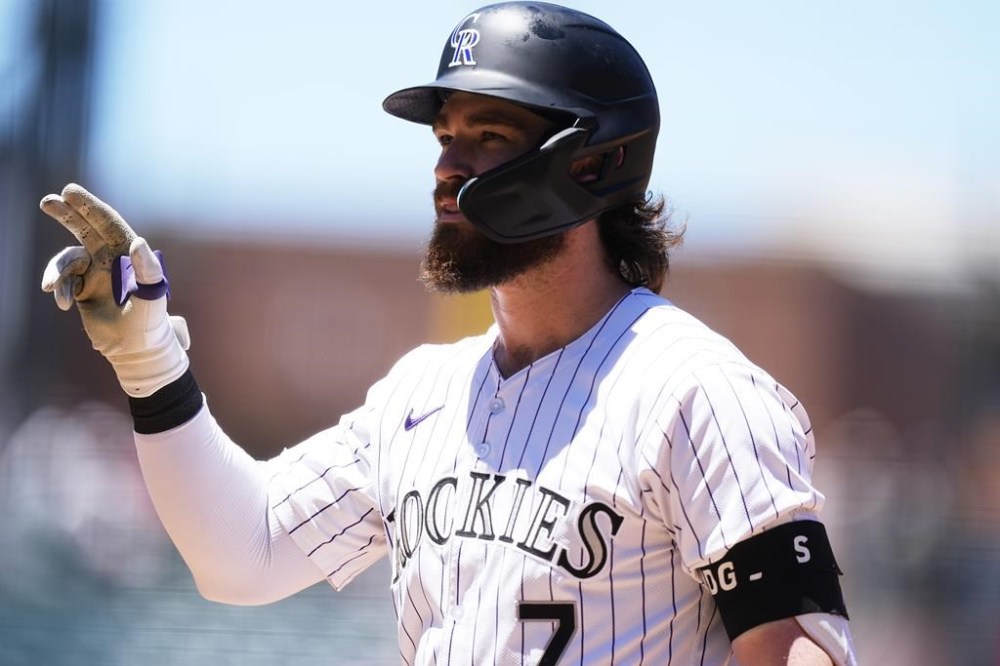 Colorado Rockies' Brendan Rodgers gestures to the dugout after driving in two runs off Cincinnati Reds starting pitcher Graham Ashcraft in the first inning of a baseball game Wednesday, June 5, 2024, in Denver. (AP Photo/David Zalubowski)