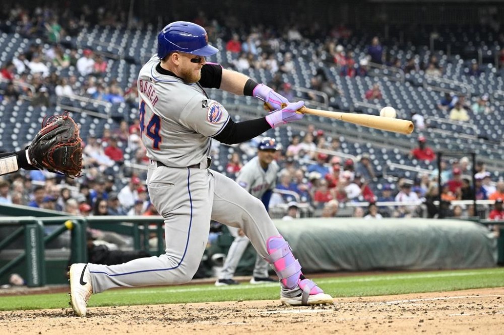 New York Mets' Harrison Bader hits a double that scored two runs during the sixth inning of a baseball game against the Washington Nationals, Wednesday, June 5, 2024, in Washington. (AP Photo/Nick Wass)