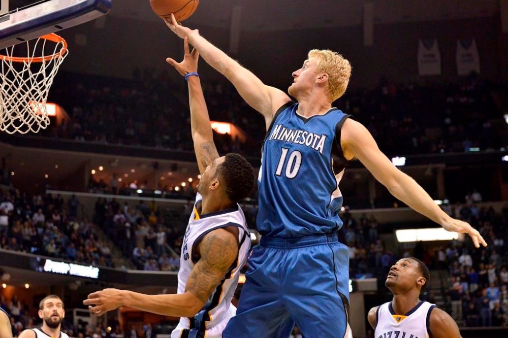 FILE - Minnesota Timberwolves forward Chase Budinger (10) shoots over Memphis Grizzlies guard Courtney Lee during the second half of an NBA basketball game Oct. 29, 2014, in Memphis, Tenn. Former NBA player Budinger is going to the Olympics — for beach volleyball. The 6-foot-7 Californian, who helped Arizona reach the Sweet 16 in 2009 before playing seven seasons with the Rockets, Timberwolves, Pacers and Suns, earned a berth with Miles Evans as the No. 2 U.S. men’s pair at the FIVB tournament Wednesday, June 5, 2024, in Ostrava, Czechia. (AP Photo/Brandon Dill, File)