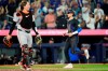Toronto Blue Jays' Cavan Biggio (right) scores on an Isiah Kiner-Falefa (not shown) game-winning RBI single as Baltimore Orioles catcher Adley Rutschman (35) looks on during ninth inning MLB baseball action in Toronto on Wednesday, June 5, 2024. THE CANADIAN PRESS/Frank Gunn