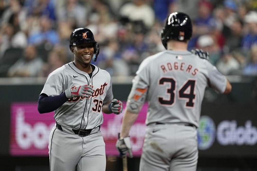 Detroit Tigers' Justyn-Henry Malloy celebrates with Jake Rogers (34) after hitting a solo home run against the Texas Rangers, his first hit in the majors, during the sixth inning of a baseball game Wednesday, June 5, 2024, in Arlington, Texas. (AP Photo/Tony Gutierrez)