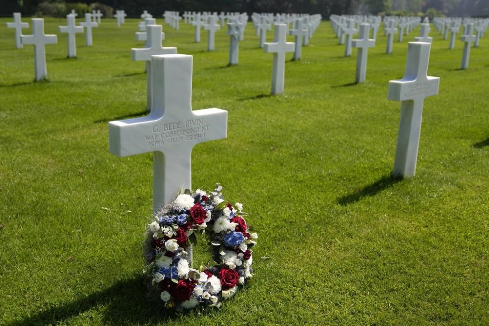 FILE - A wreath is placed in front of the grave of Associated Press photographer Bede Irvin at the Normandy American Cemetery in Colleville-sur-Mer, France on Saturday, May 11, 2024. Bede Irvin was killed July 25, 1944 near the Normandy town of St. Lo as he was photographing an Allied bombardment. (AP Photo/Virginia Mayo)