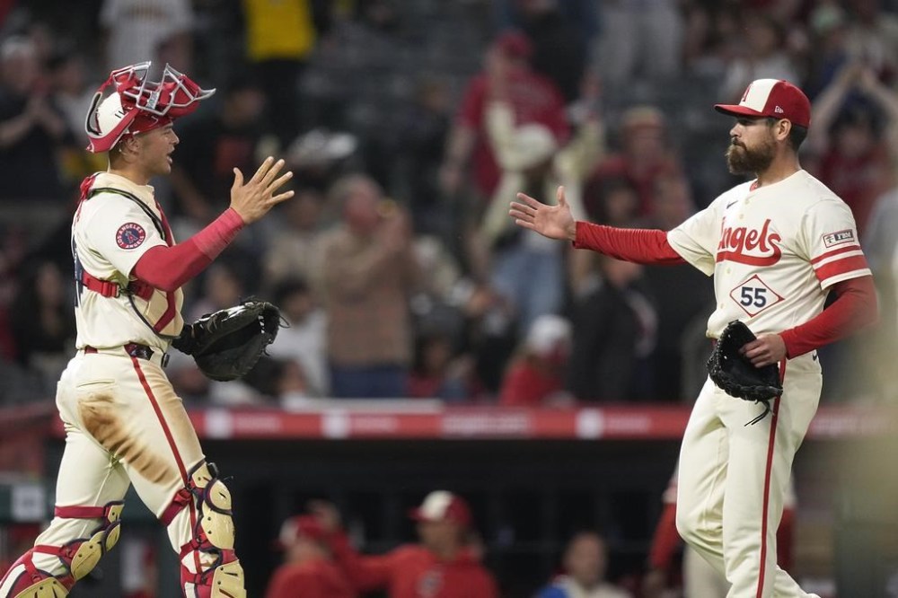 Los Angeles Angels catcher Logan O'Hoppe, left, and relief pitcher Matt Moore congratulate each other after the Angels defeated the San Diego Padres 3-2 in a baseball game Wednesday, June 5, 2024, in Anaheim, Calif. (AP Photo/Mark J. Terrill)