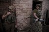 In this photo provided by the 24th Mechanised brigade press service, Ukrainian soldiers prepare to fire 120mm mortar towards Russian position on the front line at undisclosed location in Donetsk region, Ukraine, Monday, June 4, 2024. (Oleg Petrasiuk/Ukrainian 24 Mechanised brigade via AP)