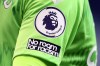 FILE - A Premier League logo is visible on the shirt of Everton's goalkeeper Jordan Pickford during the English Premier League soccer match between Tottenham Hotspur and Everton at the Tottenham Hotspur Stadium in London on Sunday, Sept. 13, 2020. The Premier League says clubs will trial two new forms of spending caps from next season. Teams in England’s top division will trial a “Squad Cost Rules” (SCR) system. SCR will limit spending on players to 85% of a club’s soccer revenue and net profit or loss on player sales. (Cath Ivill/Pool via AP, File)