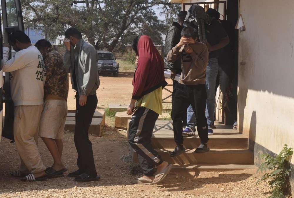 Chinese nationals outside court in Lusaka, Zambia, Friday, June 7, 2024. A Zambian court on Friday jailed 22 Chinese nationals busted over cyber-related crimes that included internet fraud and online scams targeting Zambians and other people across the world. (AP Photo)