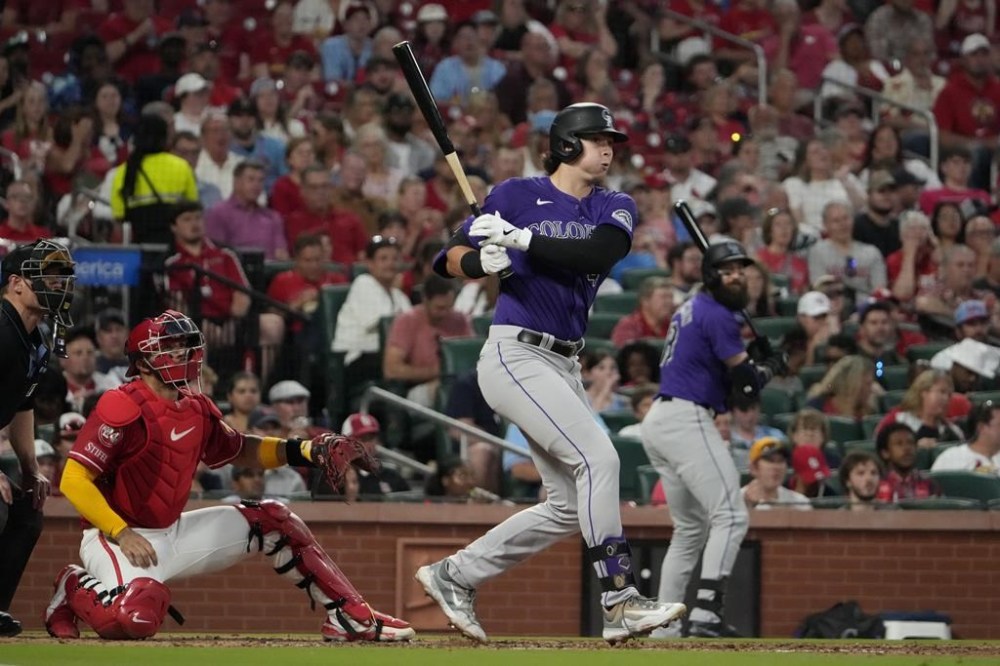 Colorado Rockies' Michael Toglia follows through on a three-run triple during the fourth inning of a baseball game against the St. Louis Cardinals Friday, June 7, 2024, in St. Louis. Toglia was able to score on a throwing error by St. Louis Cardinals second baseman Nolan Gorman on the play. (AP Photo/Jeff Roberson)