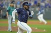 Kansas City Royals' Nelson Velazquez runs to first after hitting a fielder's choice to score the winning run during the ninth inning of a baseball game against the Seattle Mariners Friday, June 7, 2024, in Kansas City, Mo. The Royals won 10-9. (AP Photo/Charlie Riedel)
