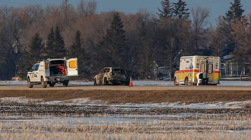 JOHN WOODS / FREE PRESS
RCMP officers investigate the grisly scene in February where the bodies of three young children were pulled from a burning vehicle.