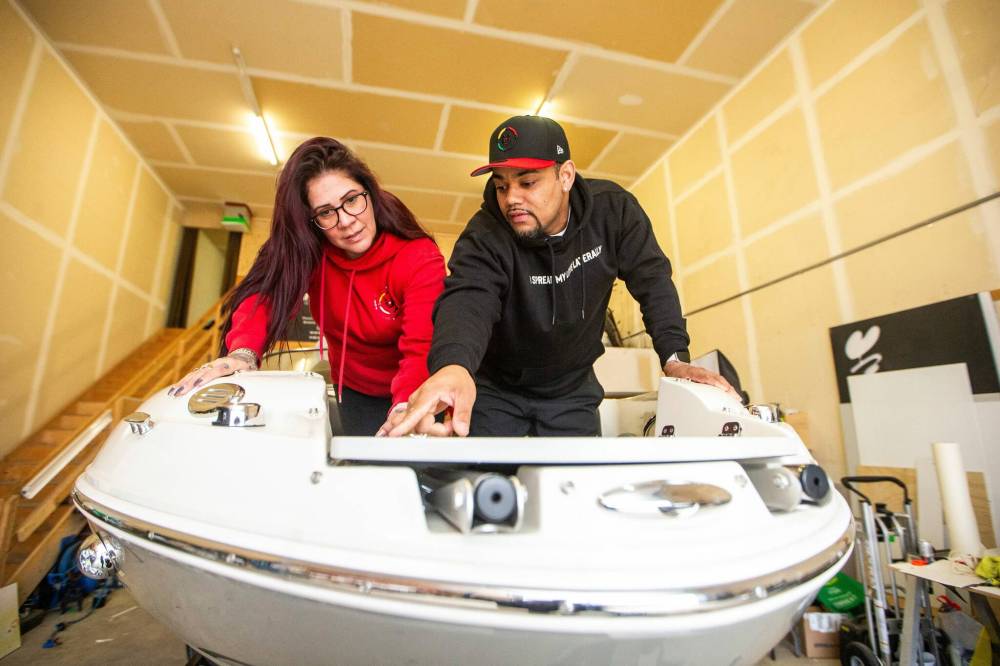 MIKAELA MACKENZIE / FREE PRESS 
                                CommUNITY204 founder Daniel Hidalgo and Alexis Tachnak (left) check out their new boat, which will be used to offer safety and support to people living in river encampments.