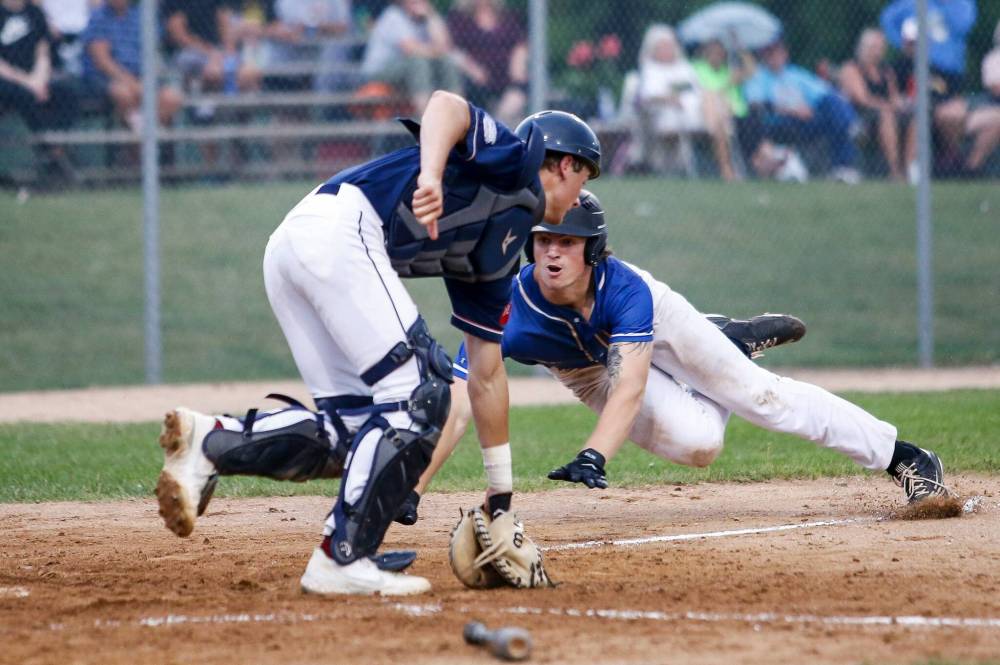 St. Boniface Legionaires‘ Ryder Duncan dives for home against the Elmwood Giants in game two of the best of five MJBL championship series at Whittier Park last July. (John Woods / Free Press files)