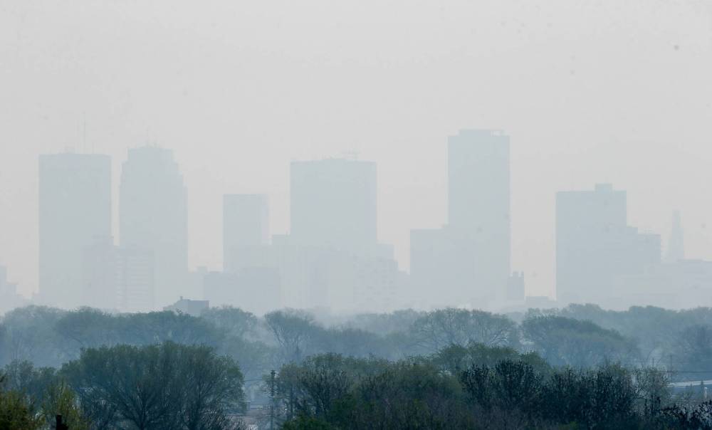 JOHN WOODS / FREE PRESS Significant smoke from a blaze near Flin Flon and carried south by heavy winds blanketed large swaths of the province — including Winnipeg — on Sunday.