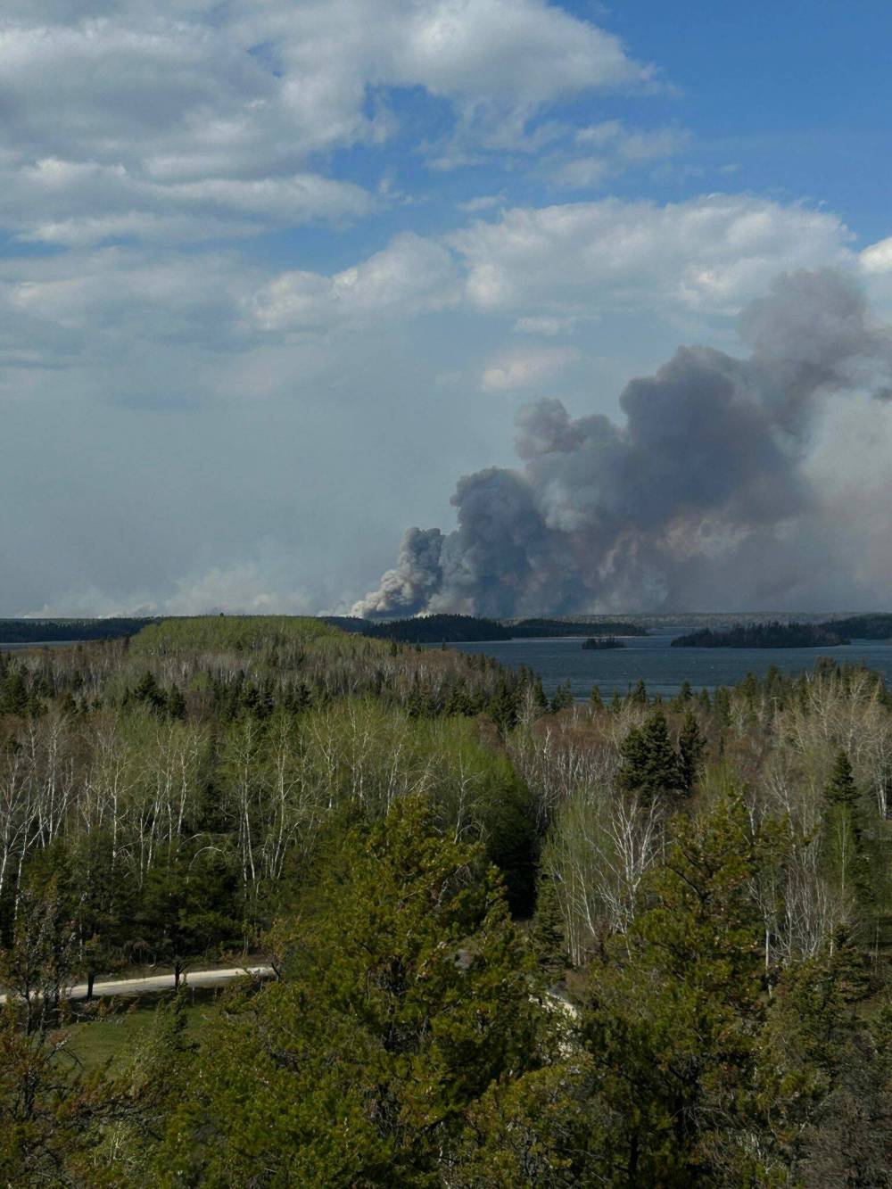An uncontrolled wildfire in northwest Manitoba forced residents living north of Flin Flon and in Cranberry Portage to evacuate Saturday night. (Submitted by Leeta Charlette-Miller)