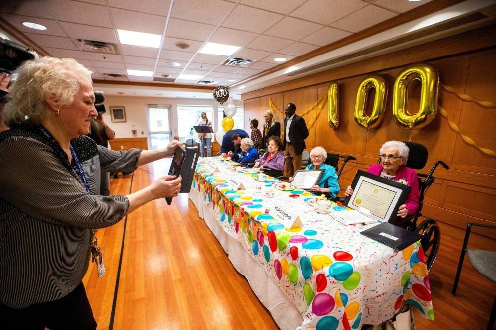 MIKAELA MACKENZIE / FREE PRESS
Centenarian residents, from left, Edith Allen (101), Adele Heidinger (100), Lily Guberman (102), and Violet Nychuk (102) take part in a group birthday celebration at the Simkin Centre on Thursday.