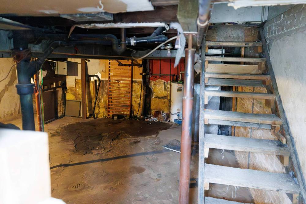 MIKE DEAL / FREE PRESS FILE A window into the basement of one of the empty suites sits open showing some minor flooding from rain.