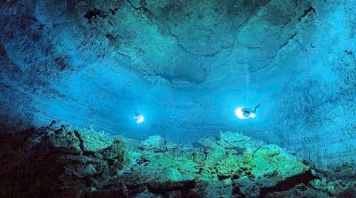 In this undated photo released by Mexico's National Institute of Anthropology and History, INAH, scuba divers explore the Hoyo Negro underwater cave, or cenote, in Tulum, Quintana Roo state, Mexico, where according INAH, a skeleton almost 13,000 years old of a prehistoric young woman was found, making it the oldest and most complete found in the Americas.  (Mexico's National Institute of Anthropology and History via AP, File)